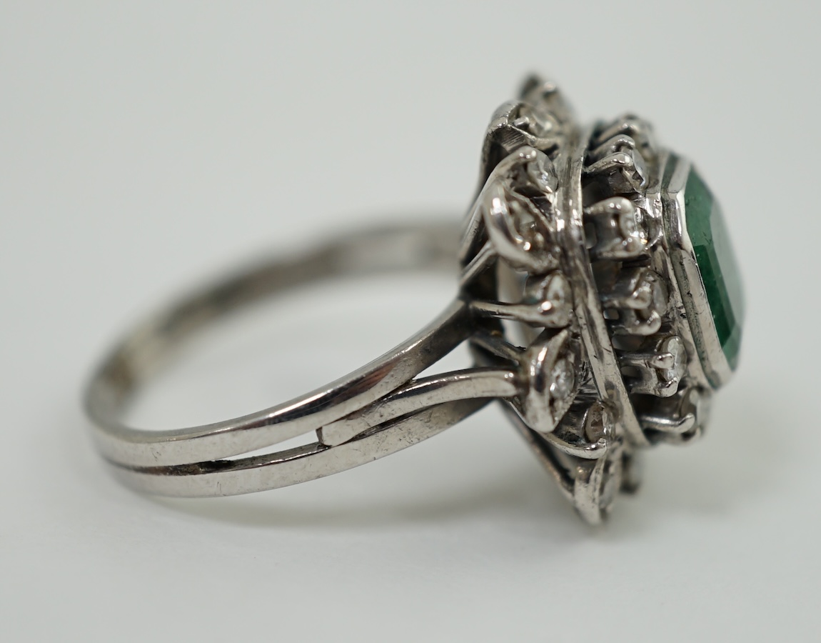 A 1960's white gold, emerald and diamond cluster set dress ring